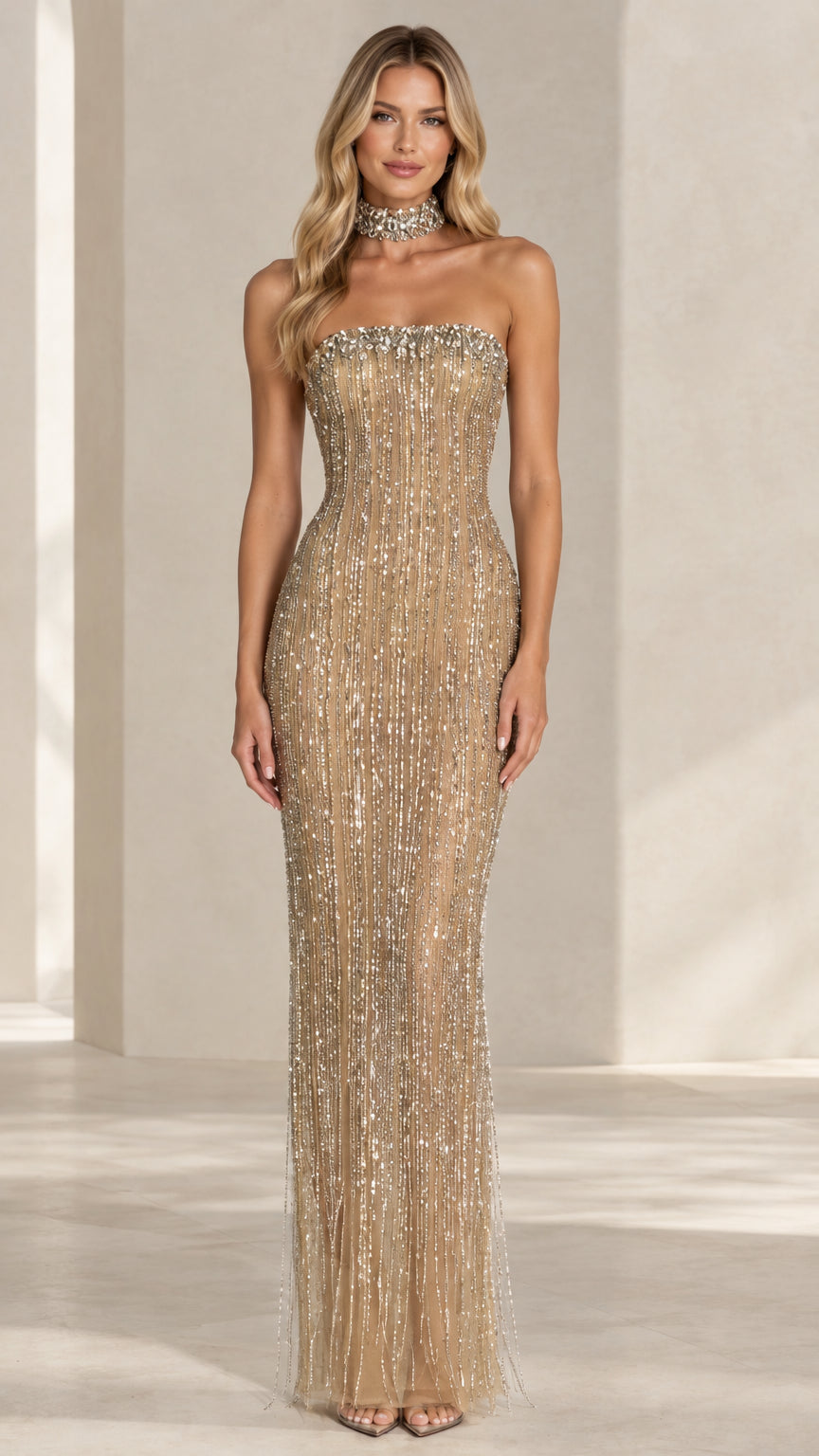 Front view of model wearing a champagne gold strapless sequin fringe maxi dress with matching choker collar