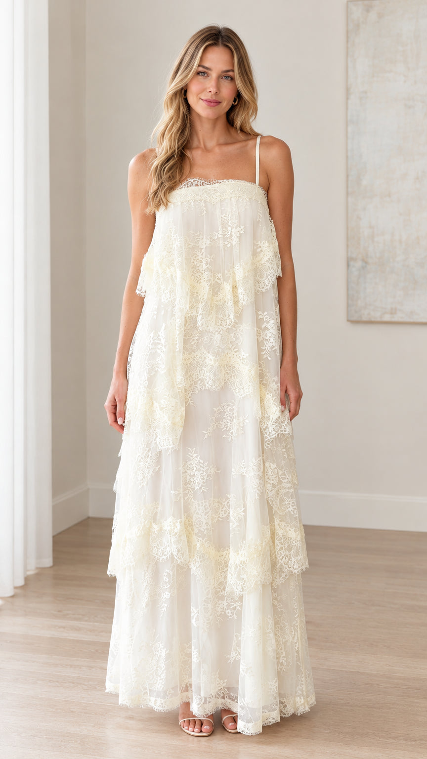 Front full-length view of woman wearing ivory tiered floral lace maxi dress with spaghetti straps