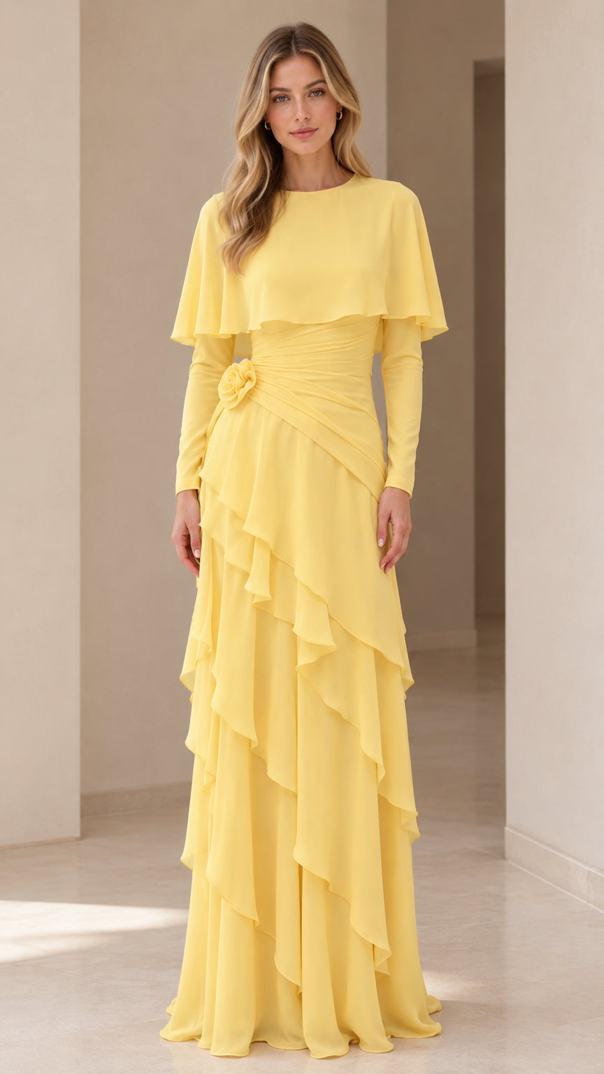 Front full-length view of the yellow capelet tiered maxi dress with long sleeves and rosette waist