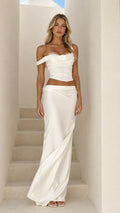 Front full view of model wearing white asymmetric lace-up corset top and draped satin maxi skirt set