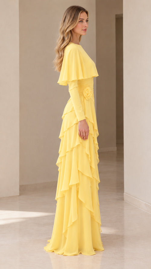 Side profile view of the yellow capelet maxi gown highlighting tiered ruffles and fit