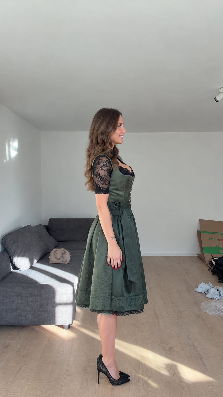 Side profile view of model showcasing Emerald Green Bavarian dirndl dress with pleated skirt