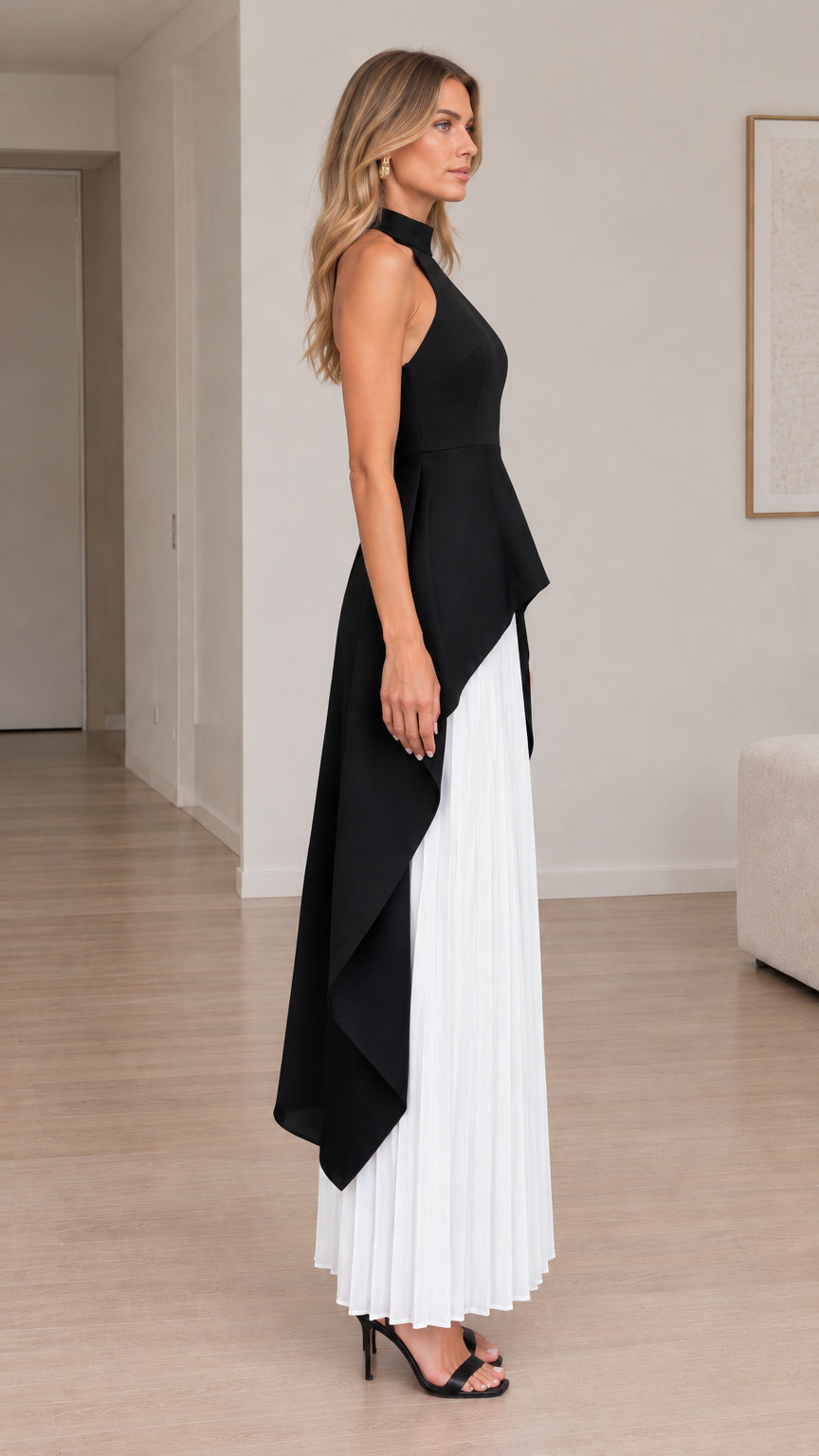 Side profile view showing cascading high-low hem and white accordion pleated maxi skirt