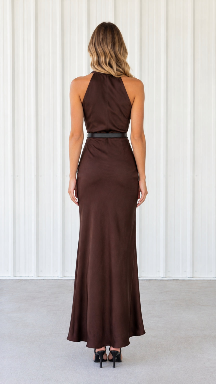 Back view of woman wearing chocolate brown halter neck sleeveless satin maxi dress