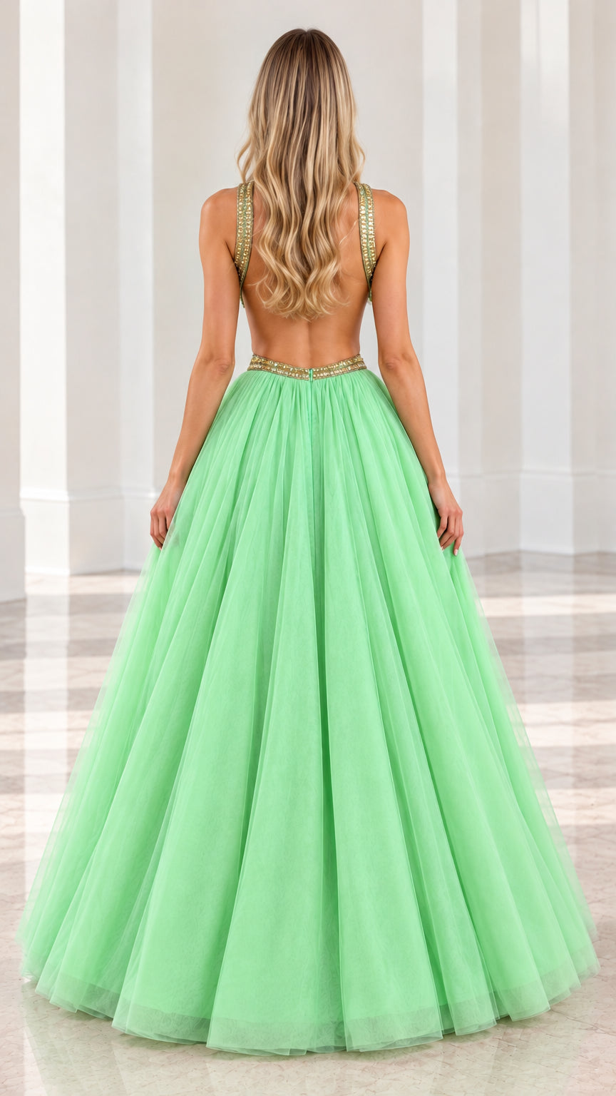 Back view of model in mint green halter gown showcasing low open back and voluminous skirt
