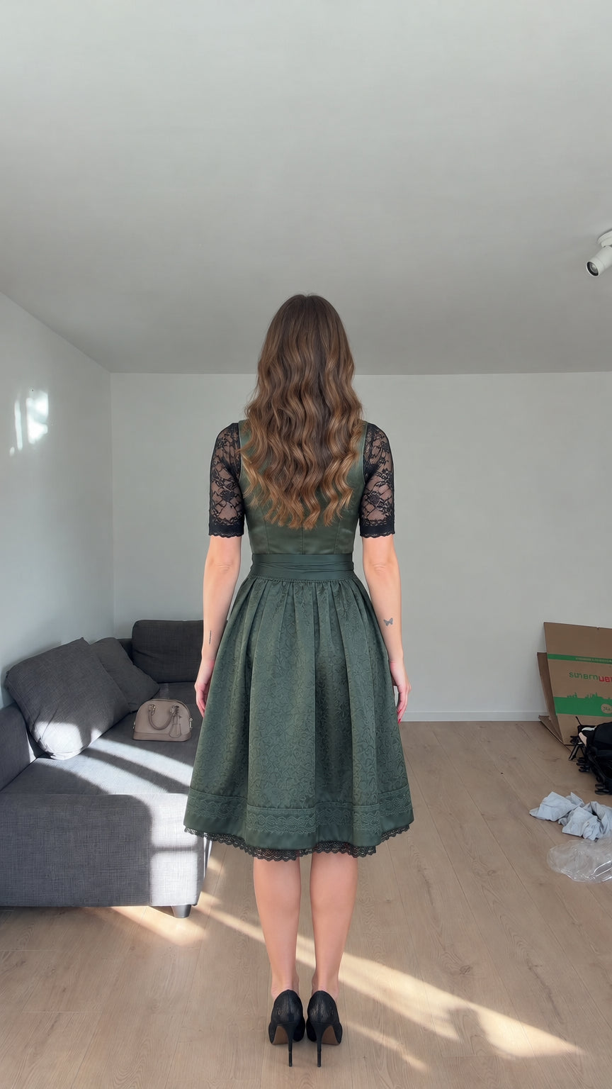 Back view of model wearing Emerald Green dirndl dress showing fitted bodice and lace sleeves