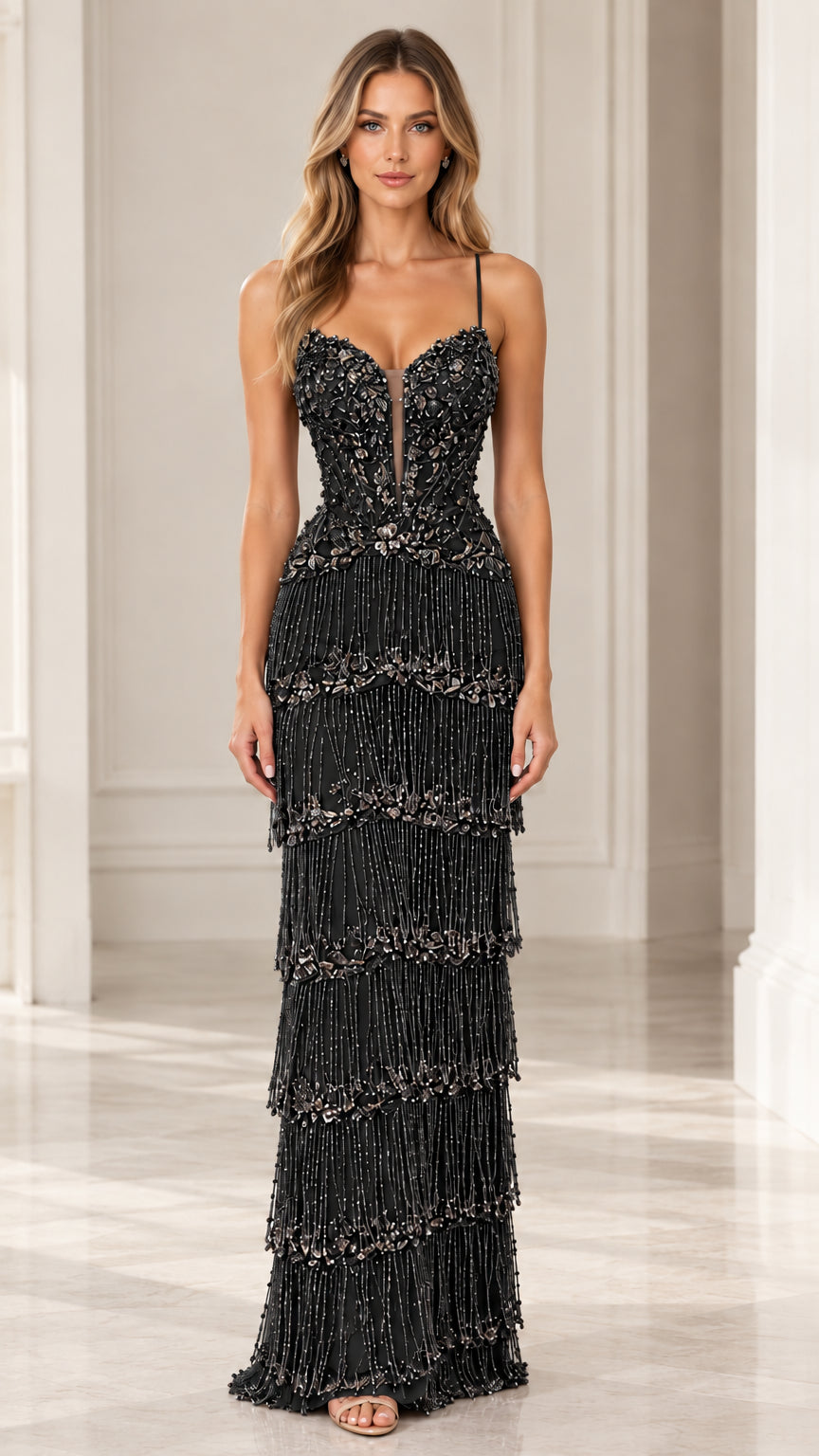 Front full-length view of woman wearing Black tiered fringe embellished evening maxi gown