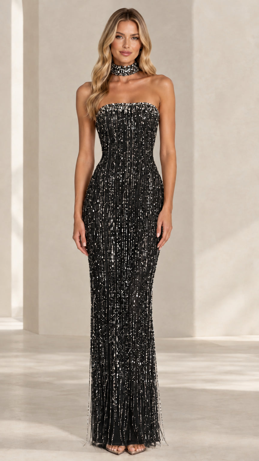 Model wearing a black strapless sequin fringe evening maxi dress with matching collar