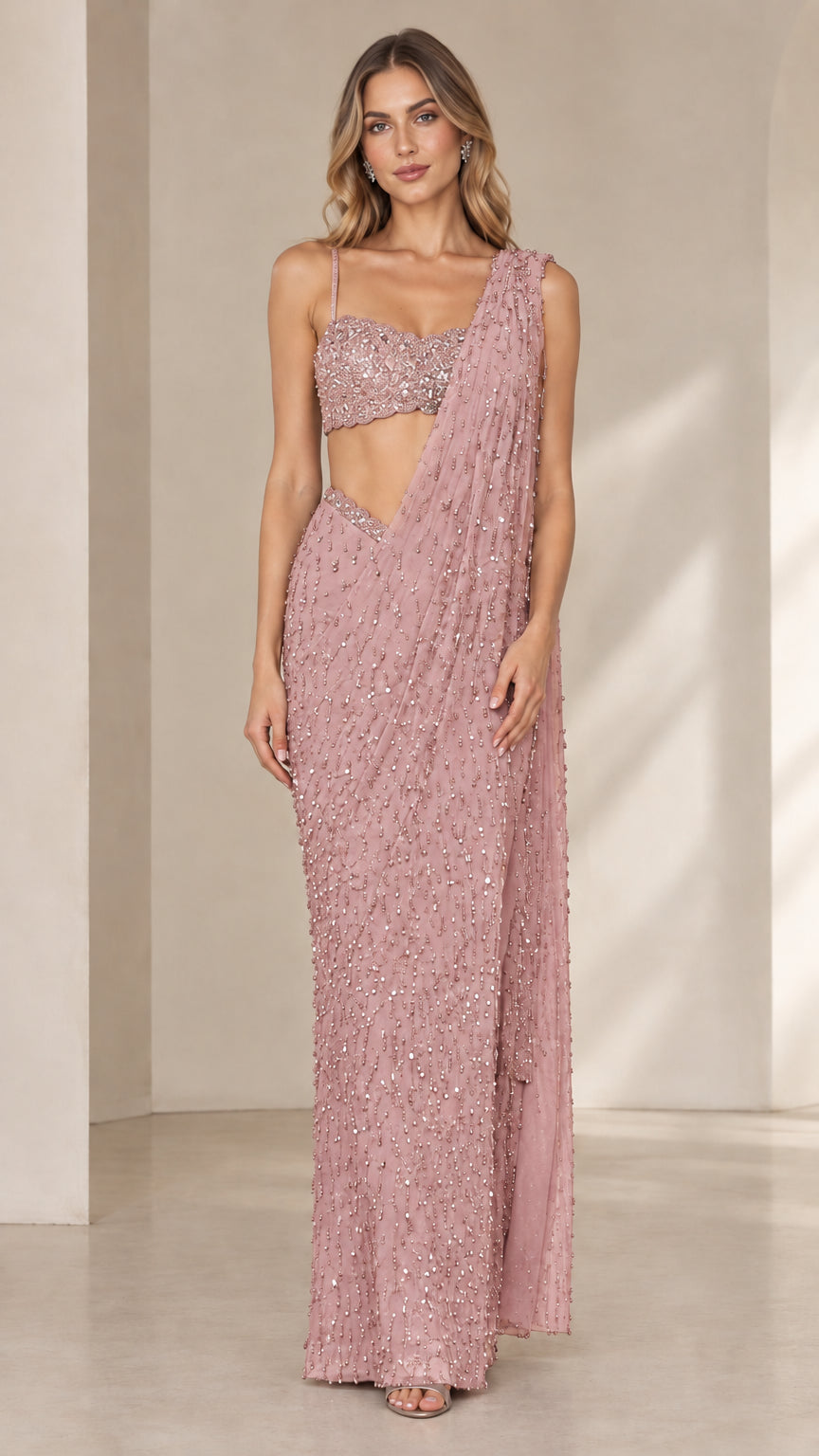 Model wearing dusty pink embellished pre-draped saree gown set