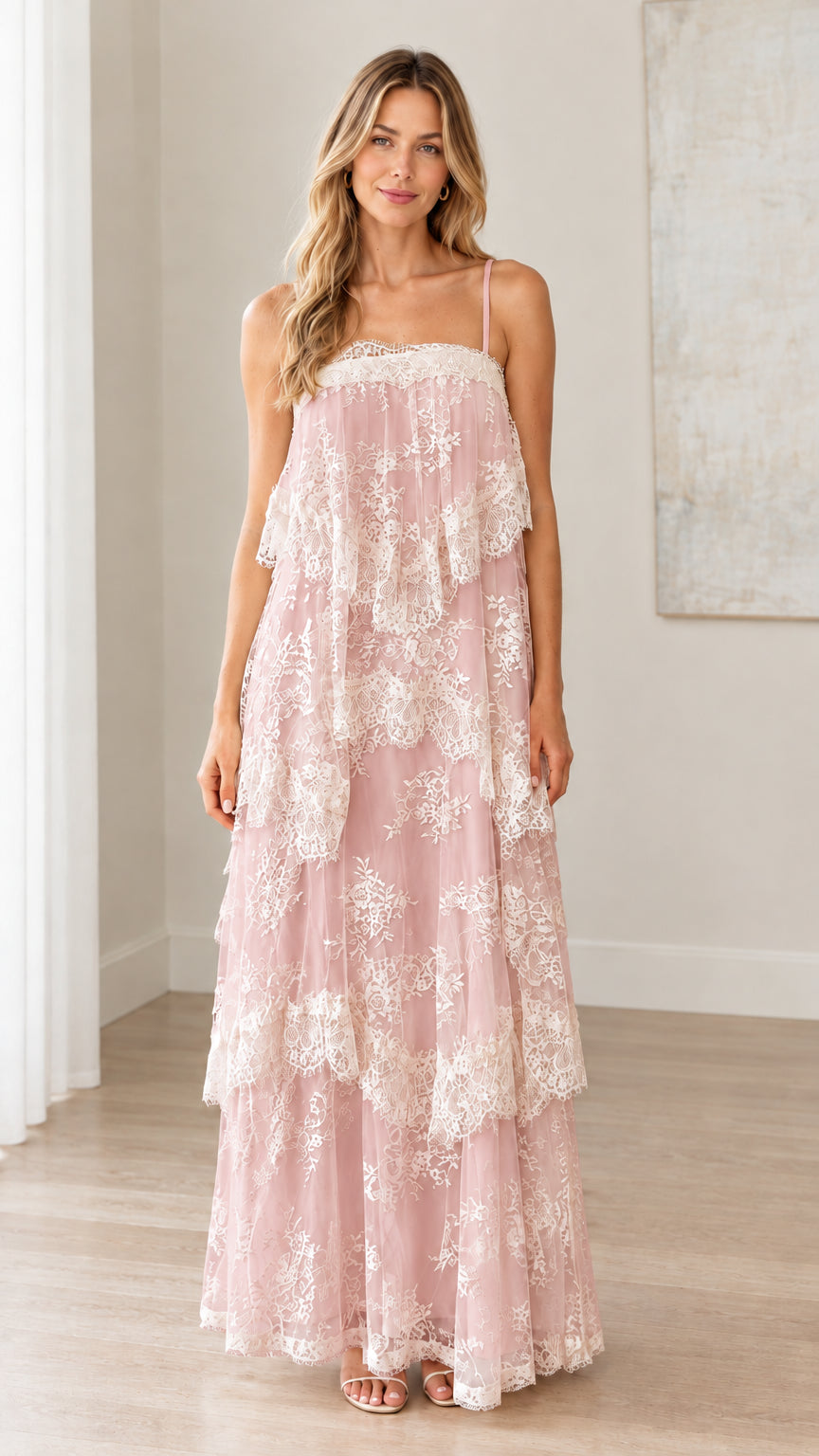 Front full-length view of woman wearing blush pink tiered floral lace maxi dress