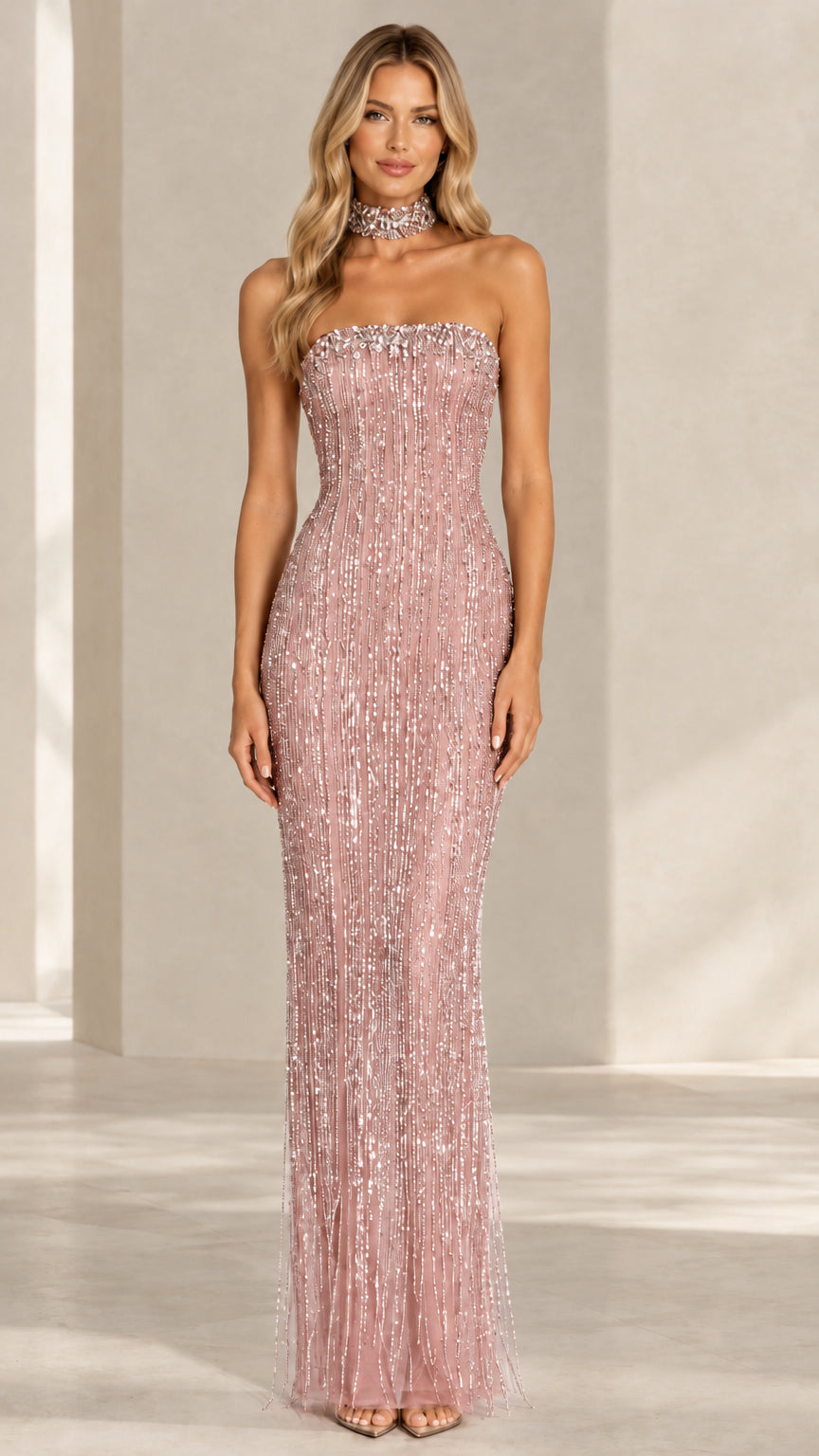 Model wearing a dusty pink strapless sequin fringe formal gown with choker