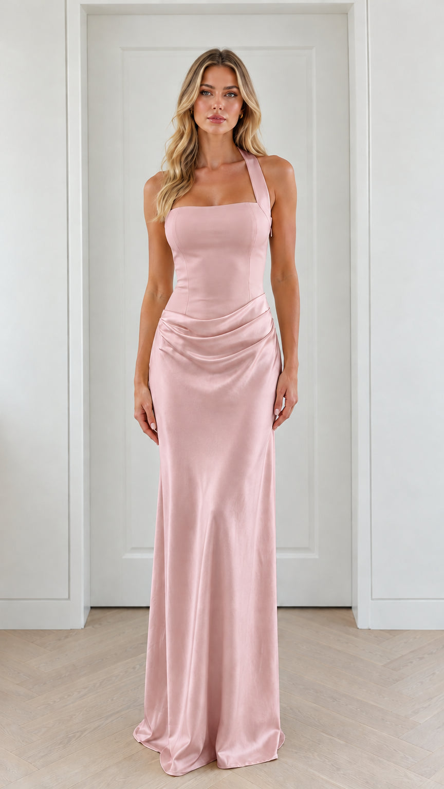 Front view of model wearing blush pink halter neck ruched satin maxi dress