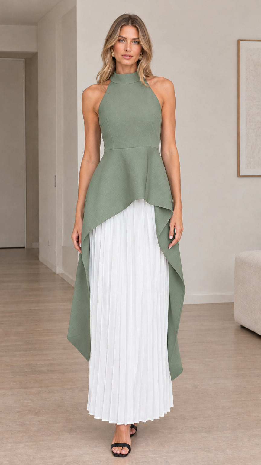 Front view of model wearing sage green halter high-low maxi dress with white pleated skirt