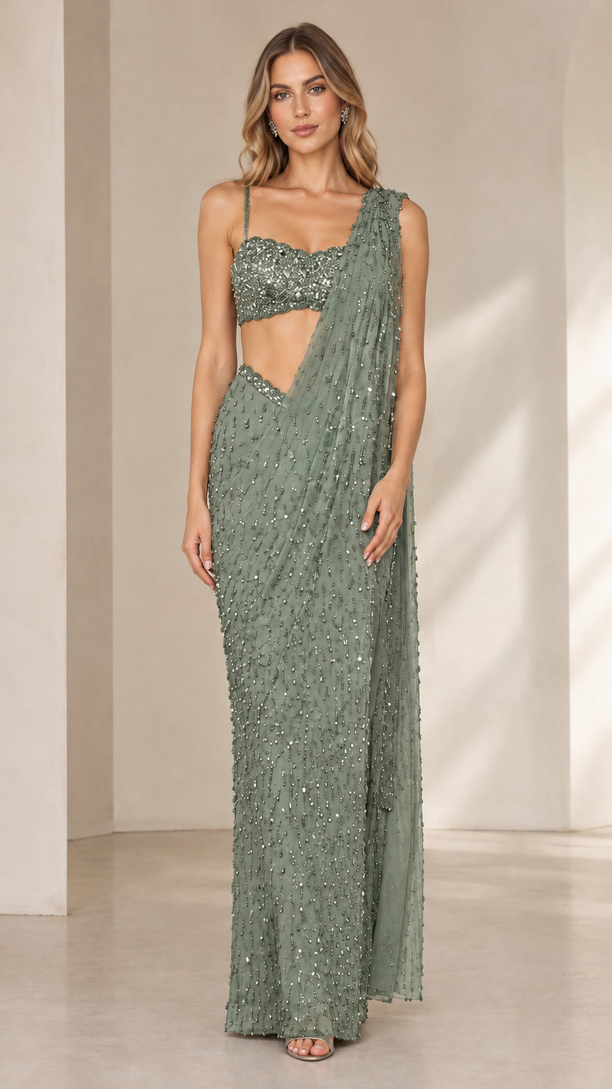 Model wearing sage green sequined pre-draped saree gown set