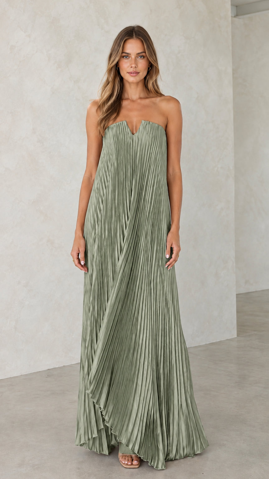 Model wearing sage green strapless pleated maxi dress