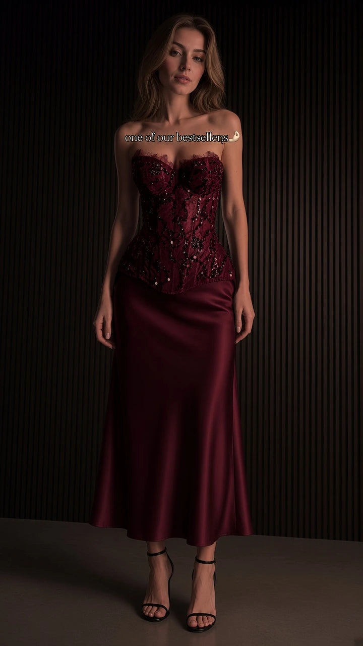 Full-length view of burgundy red beaded corset and satin skirt evening set