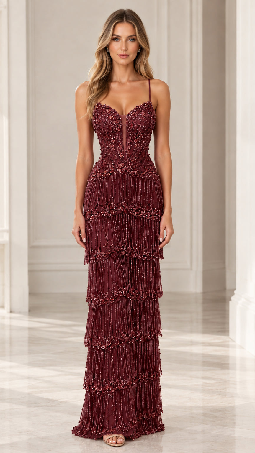 Front full-length view of woman wearing Burgundy tiered fringe embellished evening maxi gown