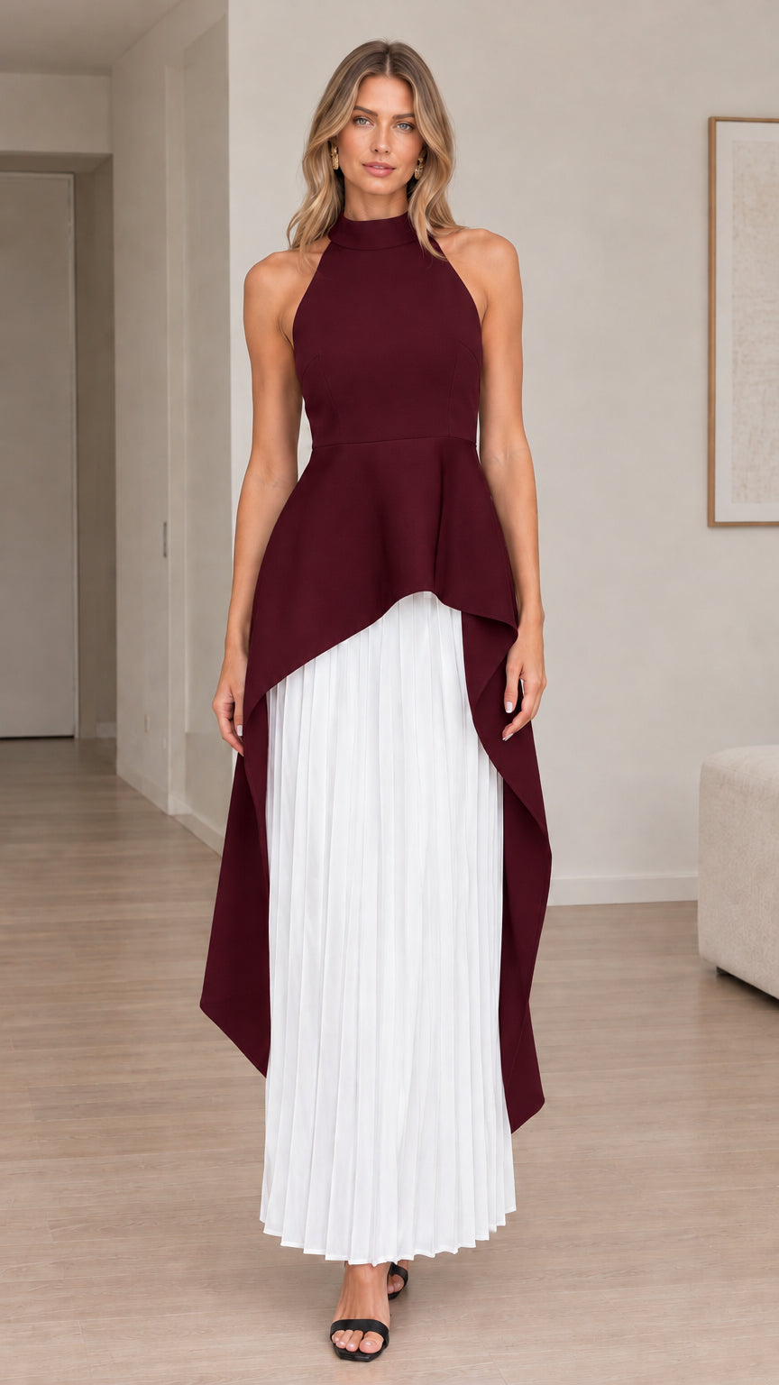 Front view of model wearing burgundy red halter high-low maxi dress with white pleated skirt