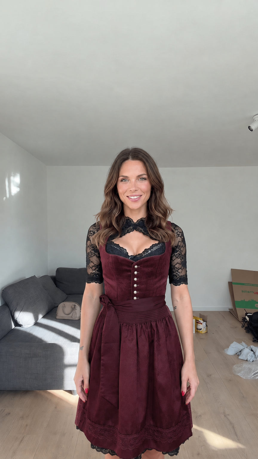 Front view of model wearing Burgundy wine red velvet dirndl dress with black lace blouse