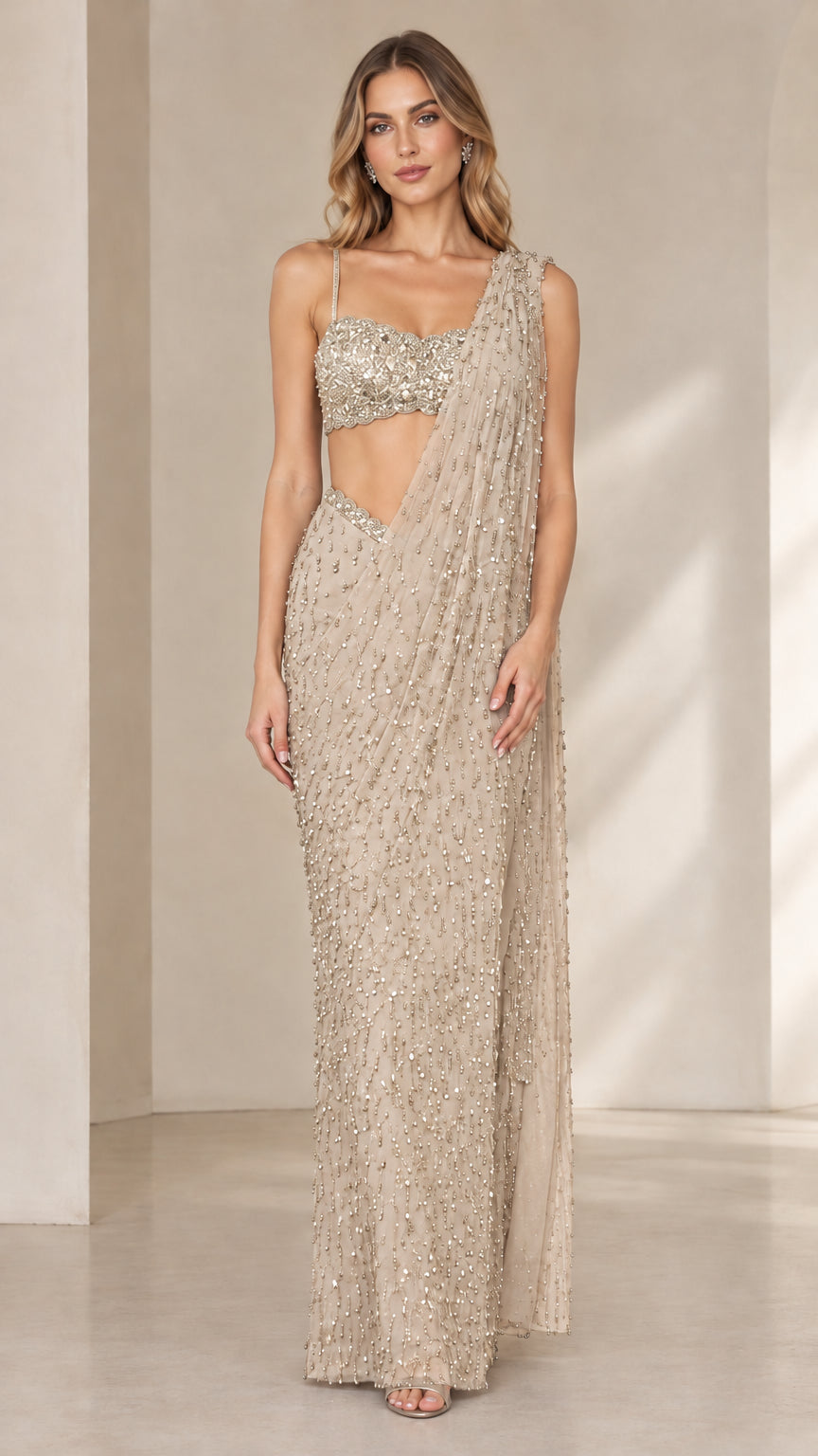 Model wearing champagne gold embellished pre-draped saree gown set